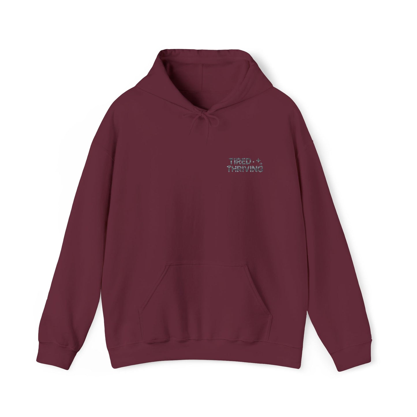 Minimal “Tired + Thriving” Embodied hoodie. Cozy fleece, unisex fit, durable chest graphic—everyday streetwear for busy days that still thrive.