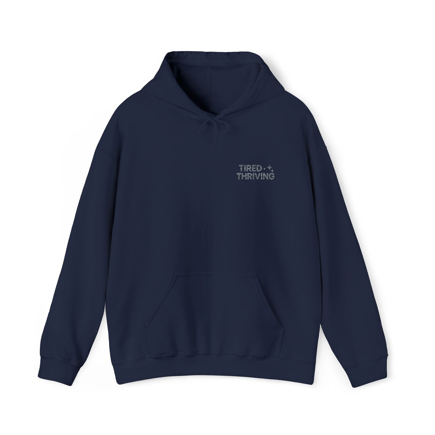 Minimal “Tired + Thriving” Embodied hoodie. Cozy fleece, unisex fit, durable chest graphic—everyday streetwear for busy days that still thrive.