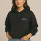 Minimal “Tired + Thriving” Embodied hoodie. Cozy fleece, unisex fit, durable chest graphic—everyday streetwear for busy days that still thrive.
